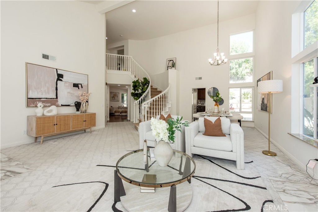 19933 Hidden Springs Road Walnut, CA 91789 - Photo 5 of 26 a living room with furniture a chandelier and a flat screen tv