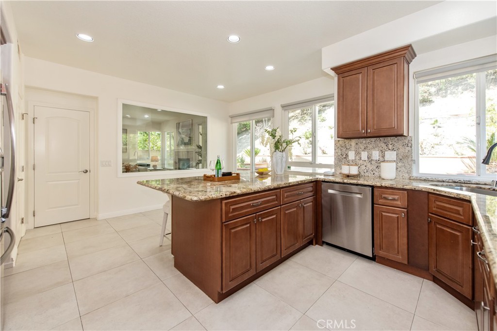19933 Hidden Springs Road Walnut, CA 91789 - Photo 9 of 26 a kitchen with stainless steel appliances granite countertop a sink and cabinets