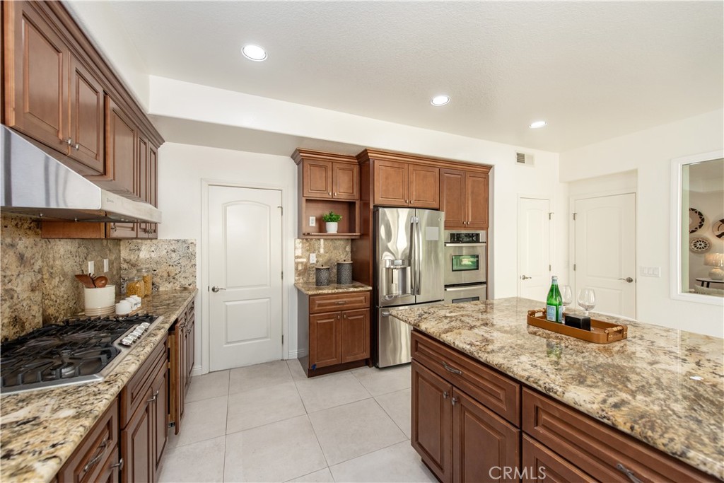 19933 Hidden Springs Road Walnut, CA 91789 - Photo 10 of 26 a kitchen with stainless steel appliances granite countertop a refrigerator and a stove