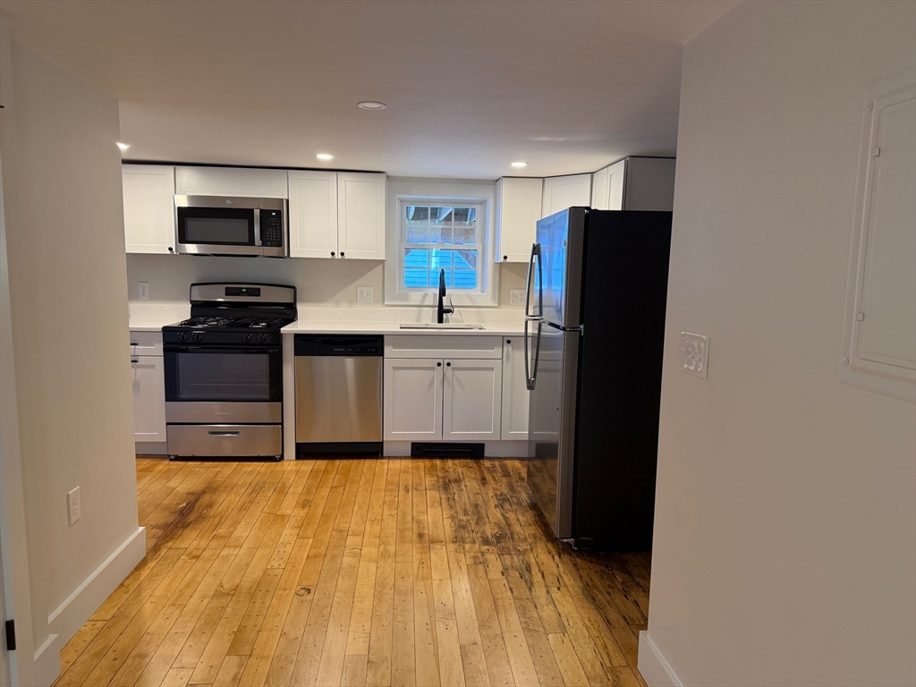 244 Main Street, Unit 1 North Andover, MA 01845 - Photo 7 of 13 a kitchen with a refrigerator and a stove top oven