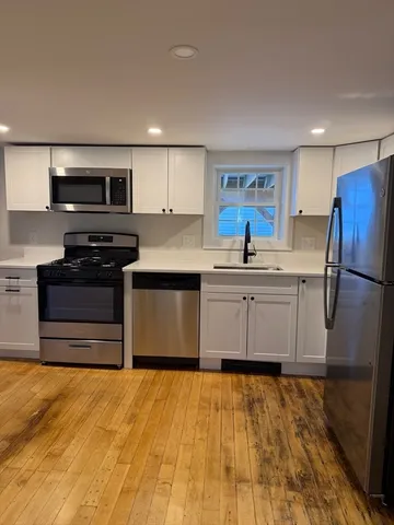 a kitchen with stainless steel appliances a stove sink and refrigerator