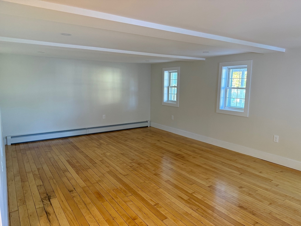 244 Main Street, Unit 1 North Andover, MA 01845 - Photo 10 of 13 a view of an empty room with wooden floor and a window