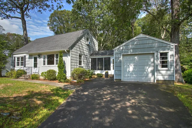 a front view of a house with a garden
