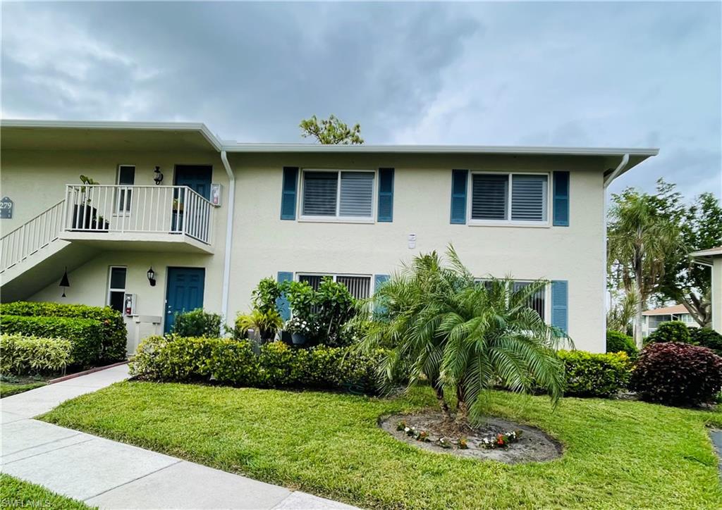 279 Albi Road, Unit 2761 Naples, FL 34112 - Photo 1 of 2 a front view of a house with a yard