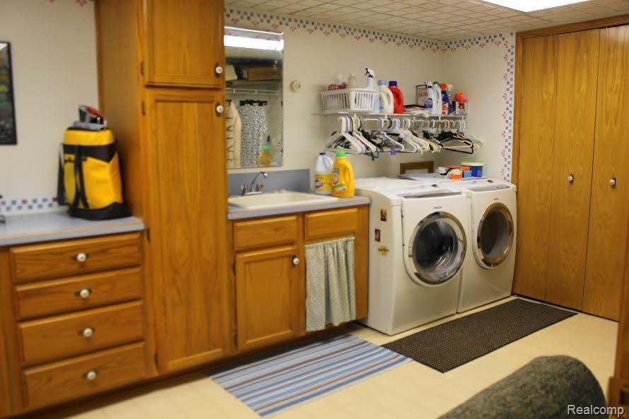 4010 Genesee Road Lapeer, MI 48446 - Photo 22 of 27 Laundry room with lots of cabinets and counter space. washer and dryer stay.