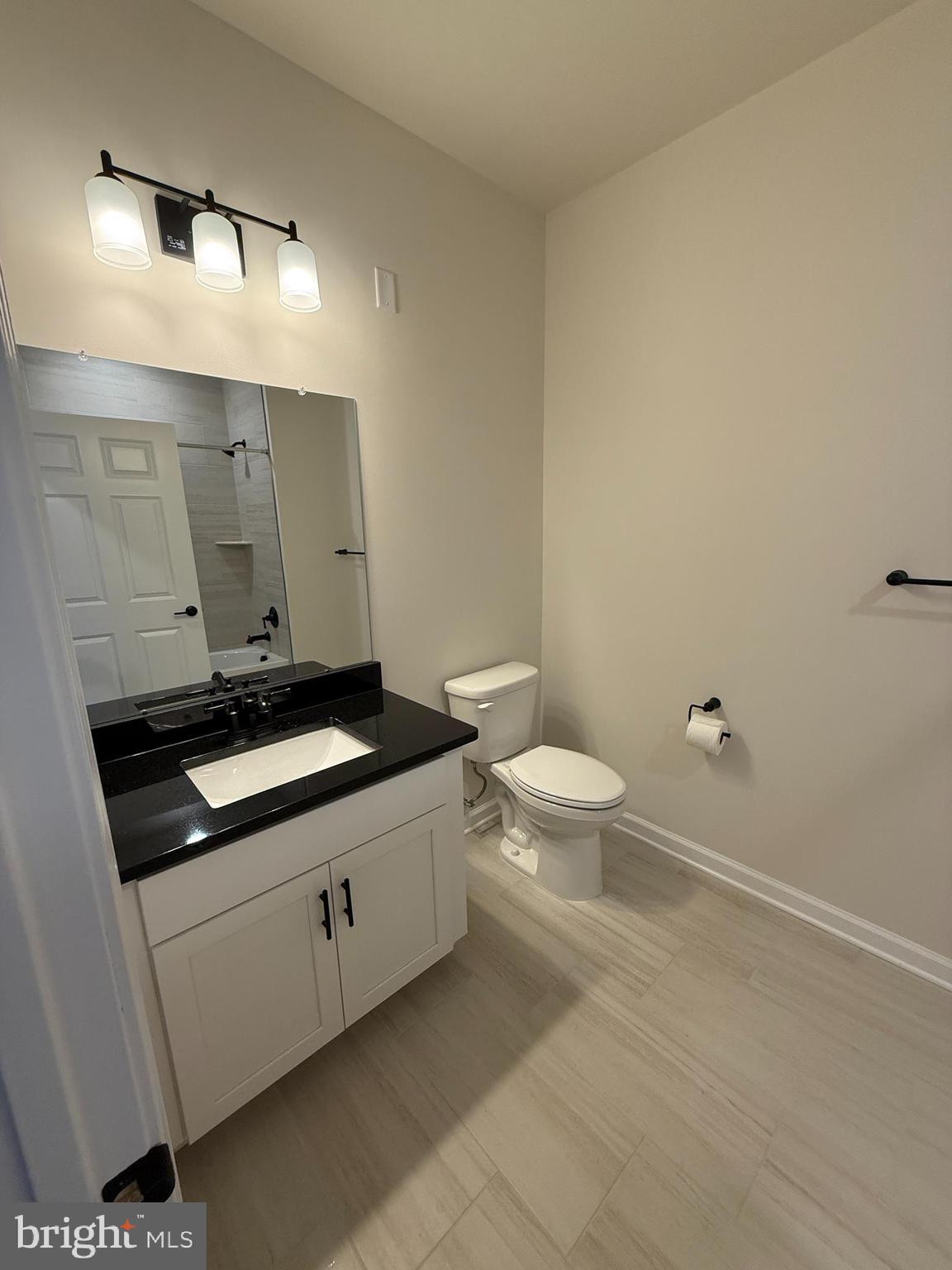 1 Culvert Drive, Unit 312 Princeton Junction, NJ 08540 - Photo 16 of 58 a bathroom with a granite countertop sink and a toilet