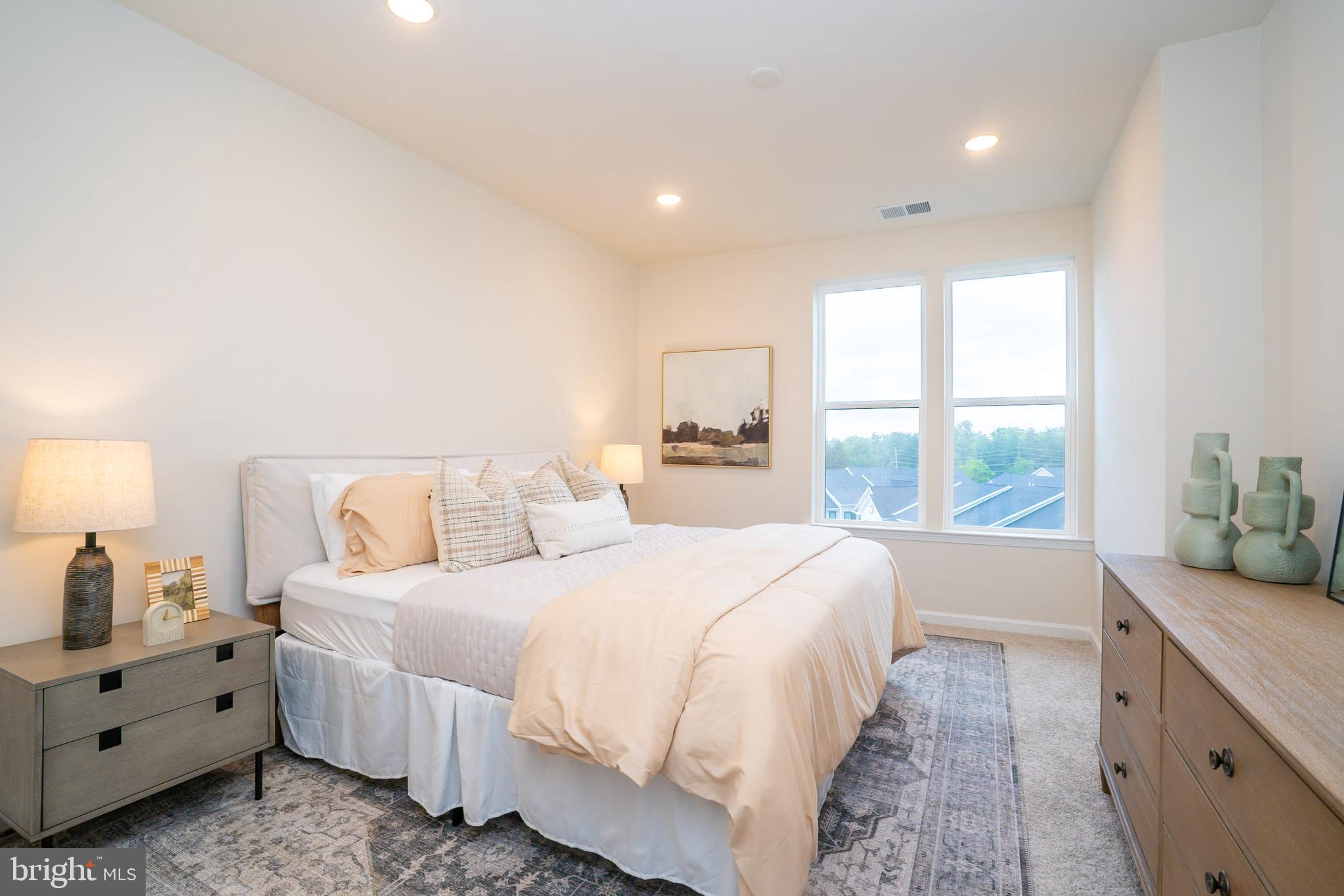1 Culvert Drive, Unit 312 Princeton Junction, NJ 08540 - Photo 24 of 58 a spacious bedroom with a bed and a window