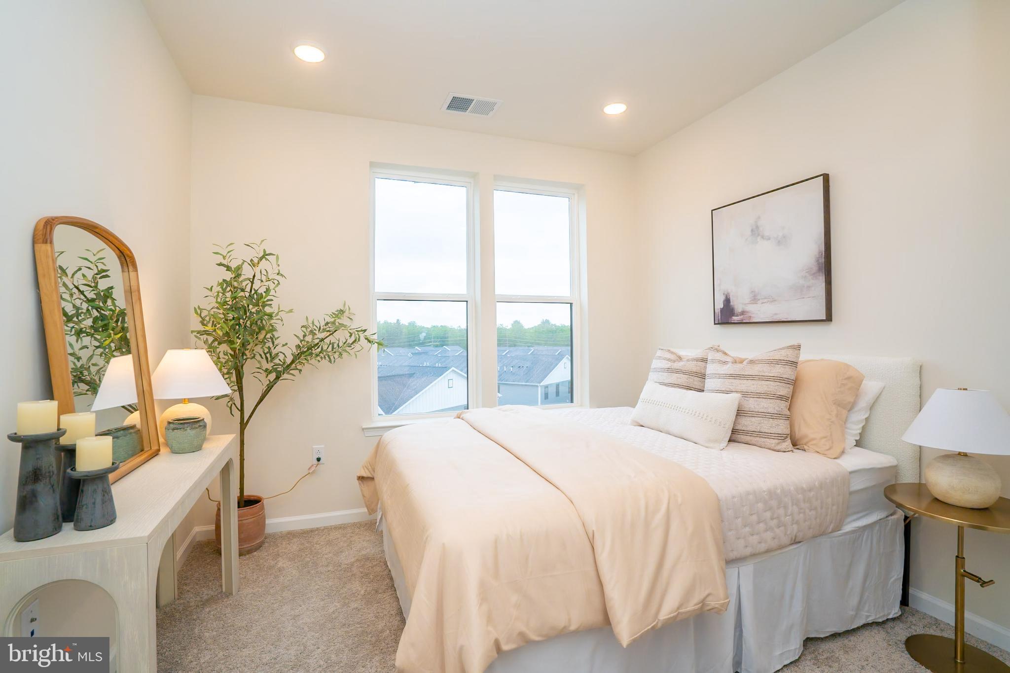 1 Culvert Drive, Unit 312 Princeton Junction, NJ 08540 - Photo 25 of 58 a bedroom with a large bed and a window