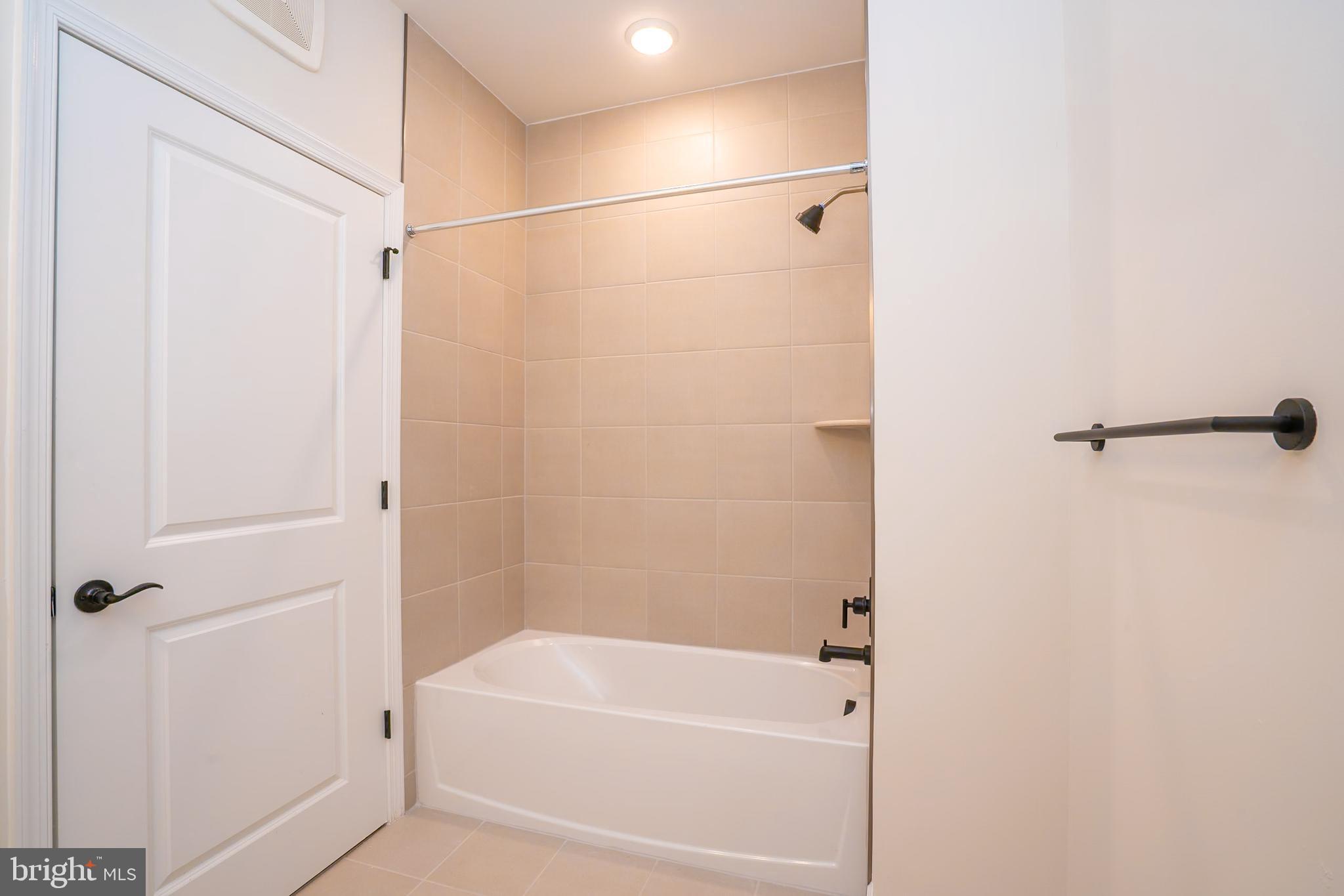 1 Culvert Drive, Unit 312 Princeton Junction, NJ 08540 - Photo 28 of 58 a bathroom with a shower and a bath tub