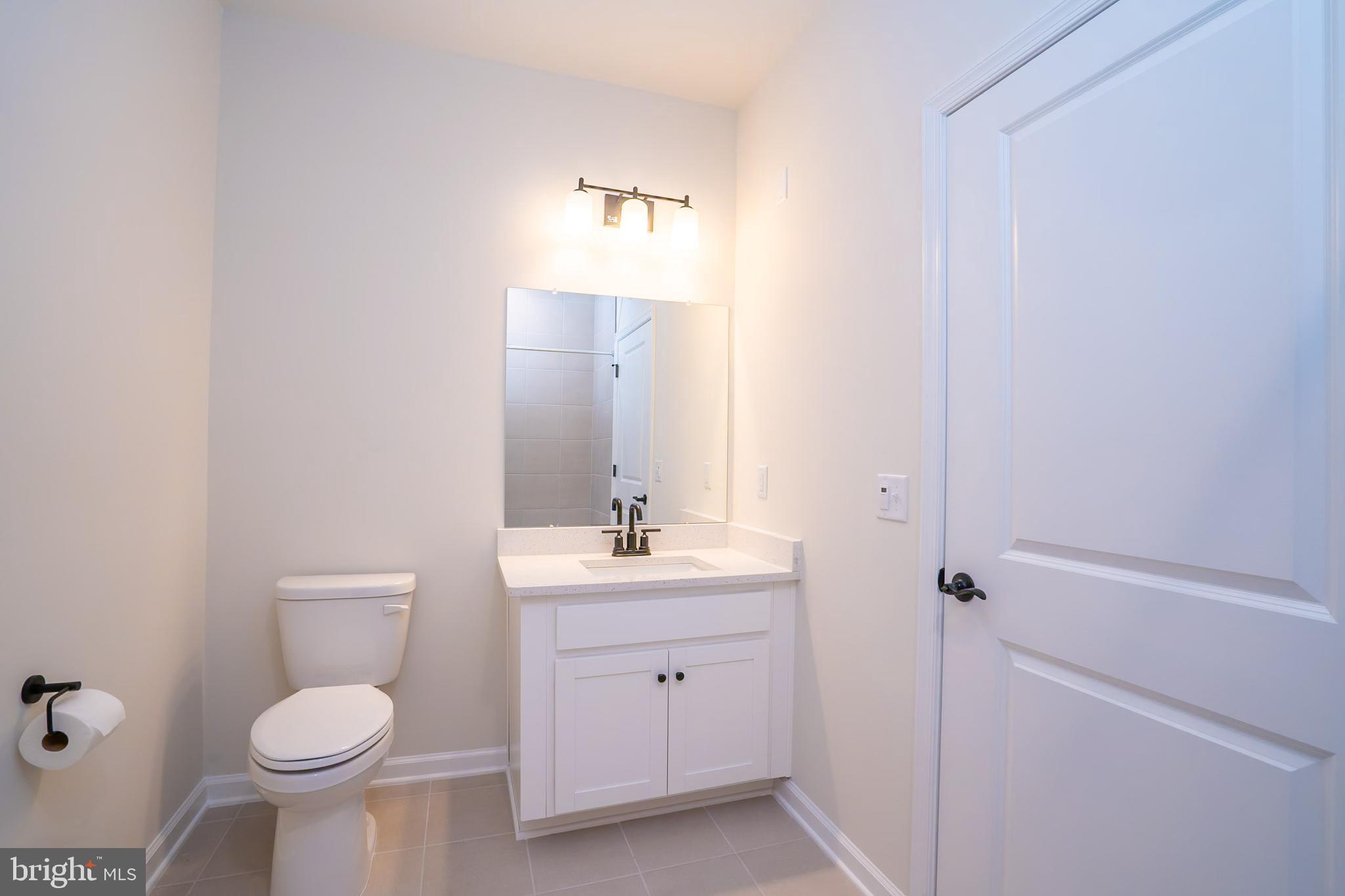 1 Culvert Drive, Unit 312 Princeton Junction, NJ 08540 - Photo 29 of 58 a bathroom with a toilet sink and mirror