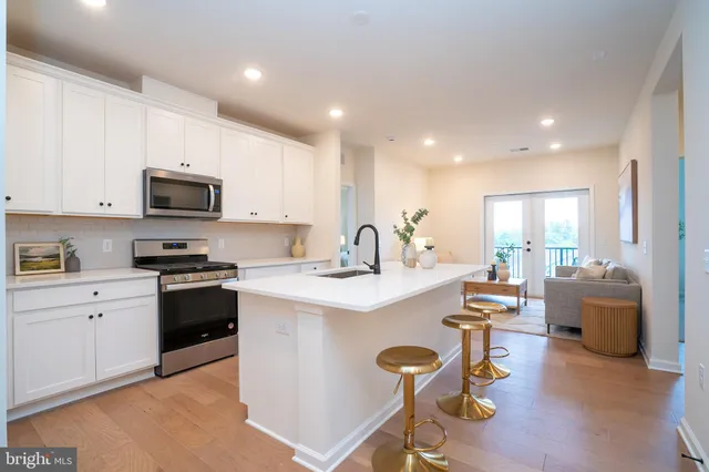 a kitchen with stainless steel appliances kitchen island granite countertop a sink and cabinets