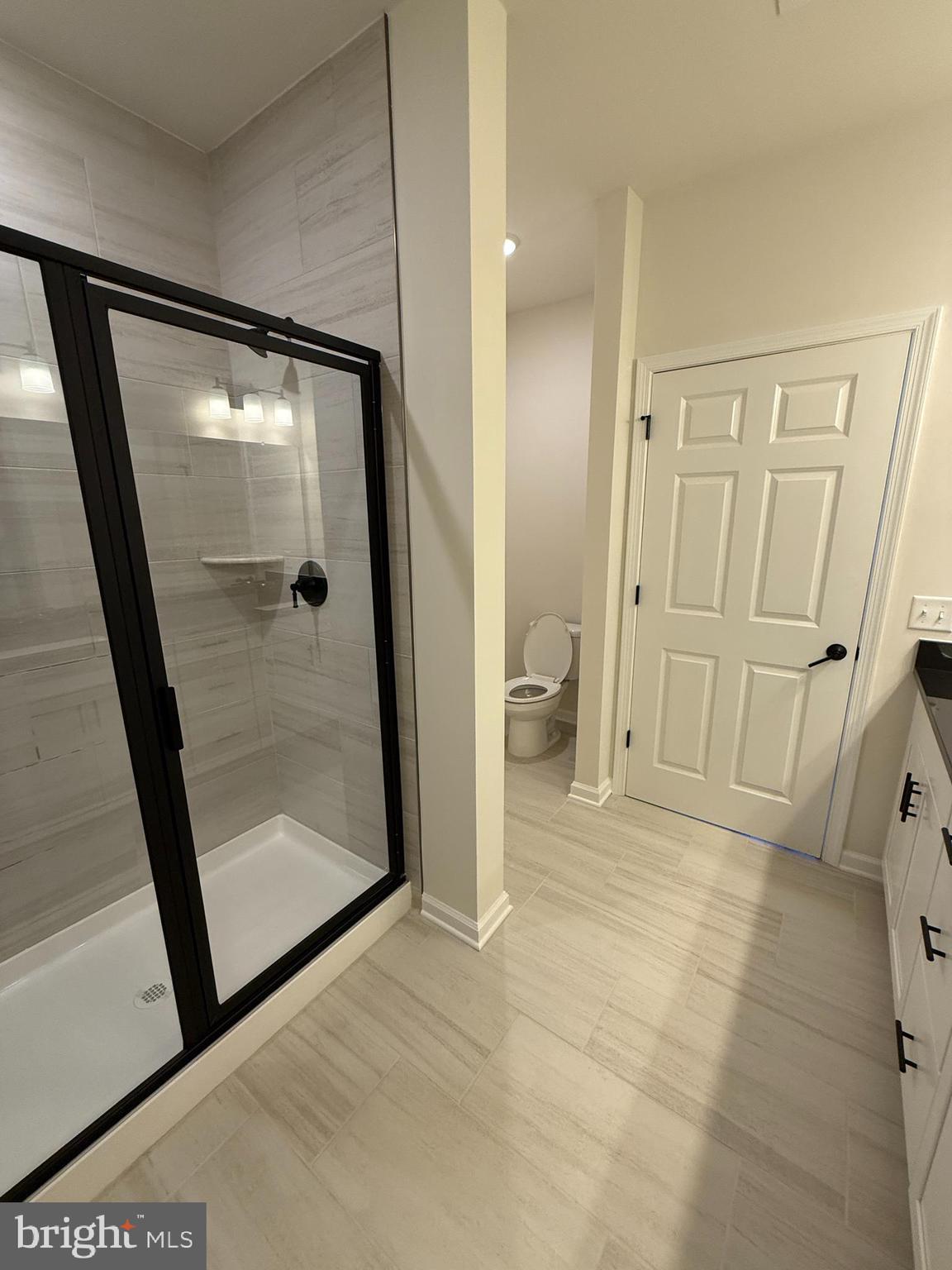 1 Culvert Drive, Unit 312 Princeton Junction, NJ 08540 - Photo 36 of 58 a bathroom with a glass door shower and toilet