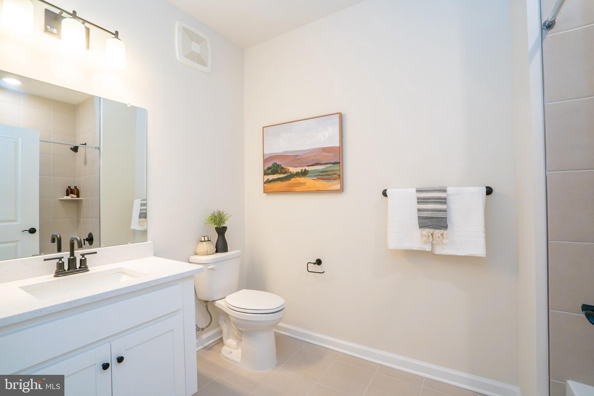 1 Culvert Drive, Unit 312 Princeton Junction, NJ 08540 - Photo 39 of 58 a bathroom with a toilet sink and mirror