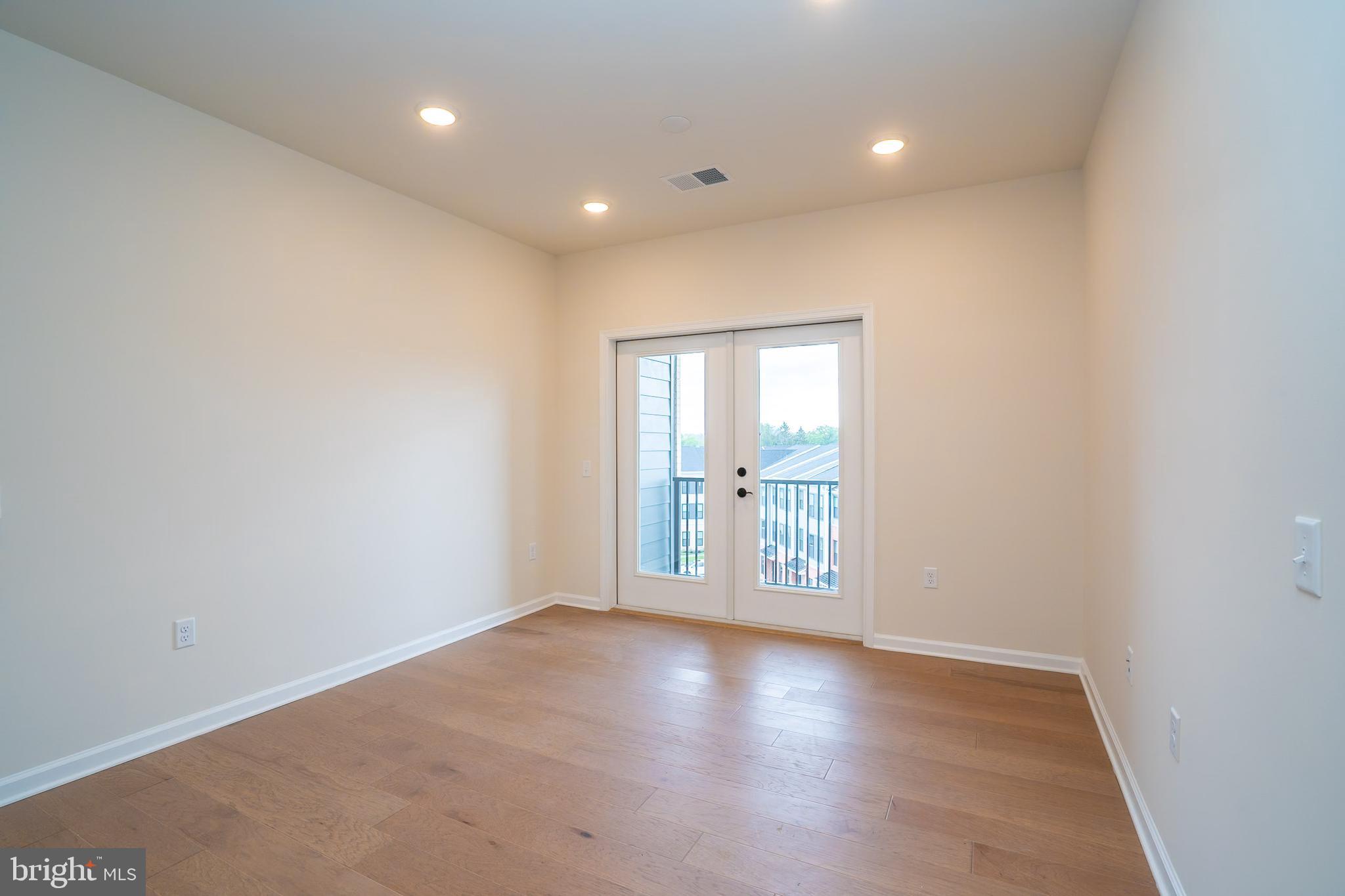 1 Culvert Drive, Unit 312 Princeton Junction, NJ 08540 - Photo 8 of 58 an empty room with wooden floor and windows