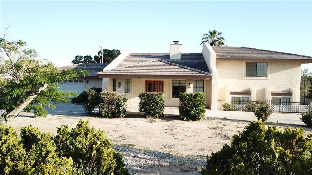 19609 Seneca Road Apple Valley, CA 92307 - Photo 1 of 37 a front view of a house with a yard