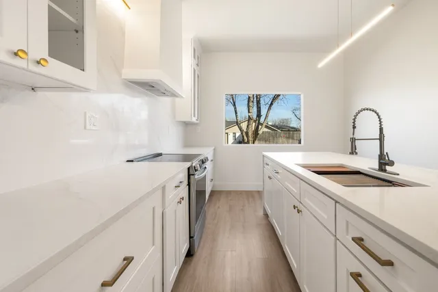 a view of kitchen with wooden floor and electronic appliances