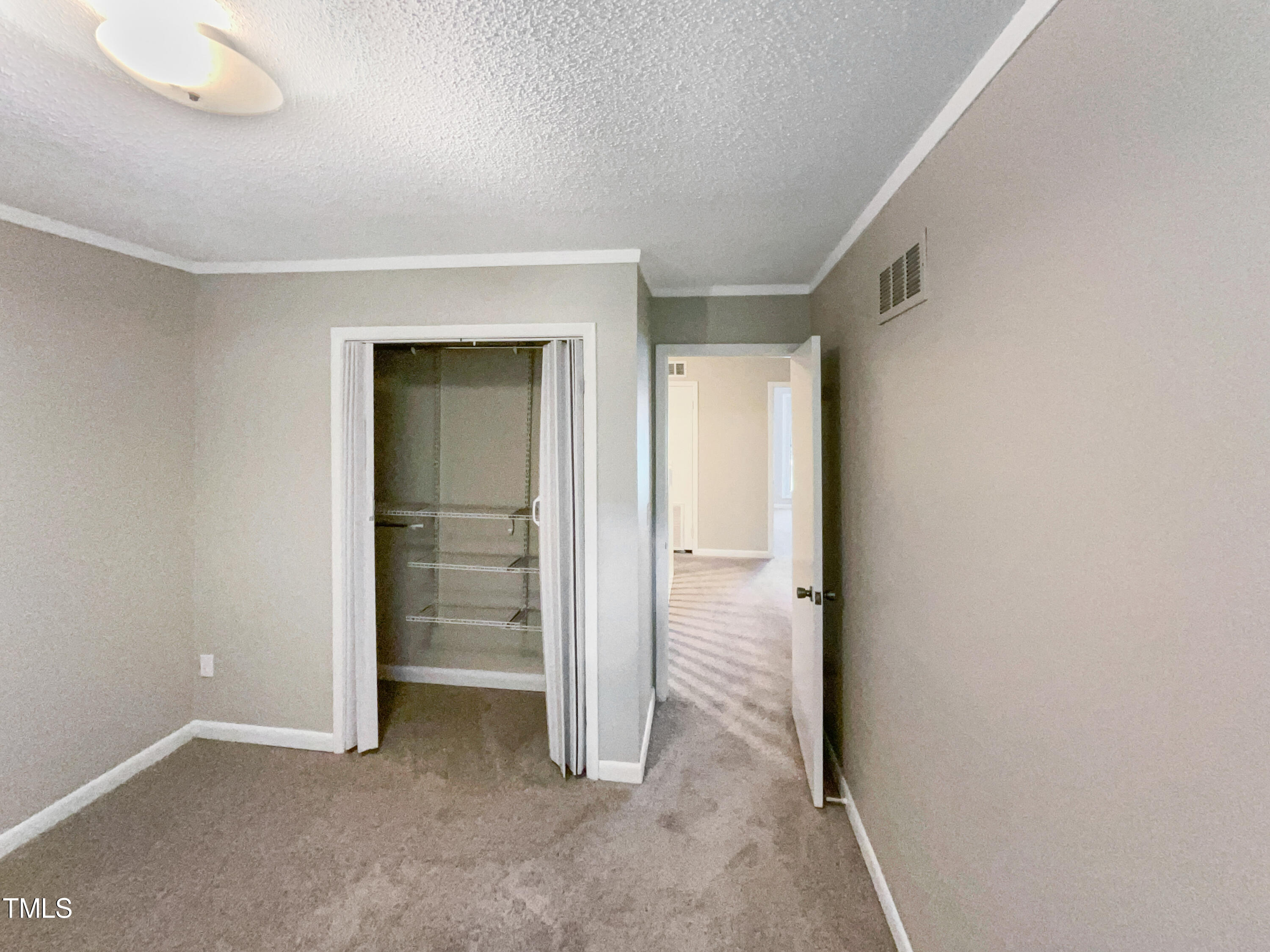 1304 Seaton Road, Unit 7 Durham, NC 27713 - Photo 12 of 18 an empty room with closet and mirror
