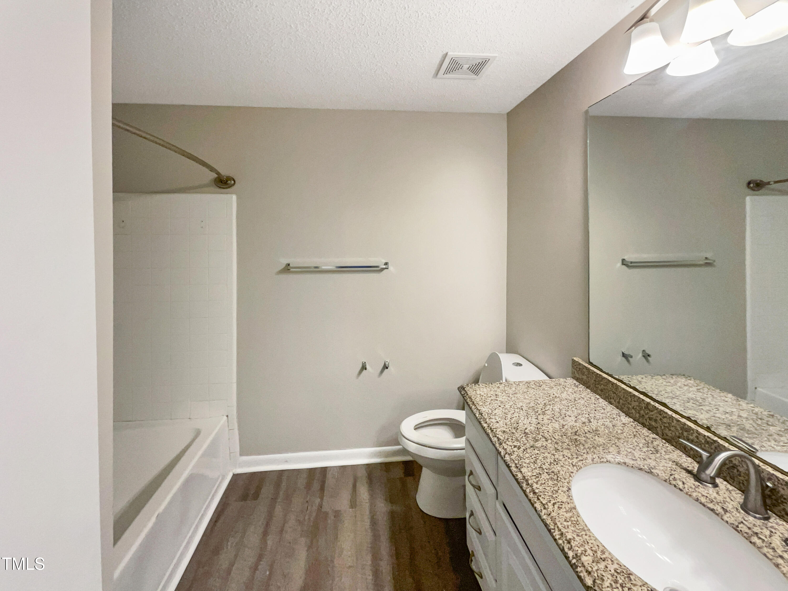 1304 Seaton Road, Unit 7 Durham, NC 27713 - Photo 15 of 18 a bathroom with a granite countertop sink a toilet and shower