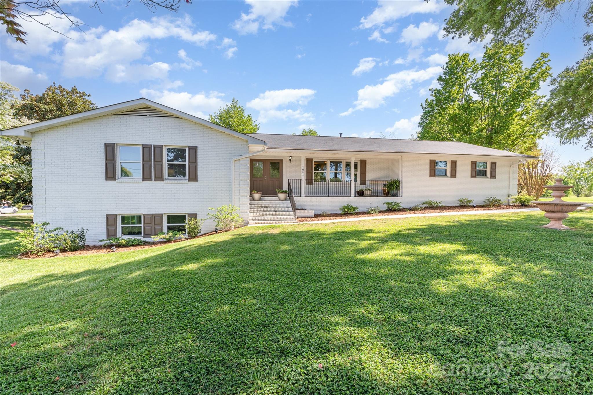 a front view of house with yard and green space