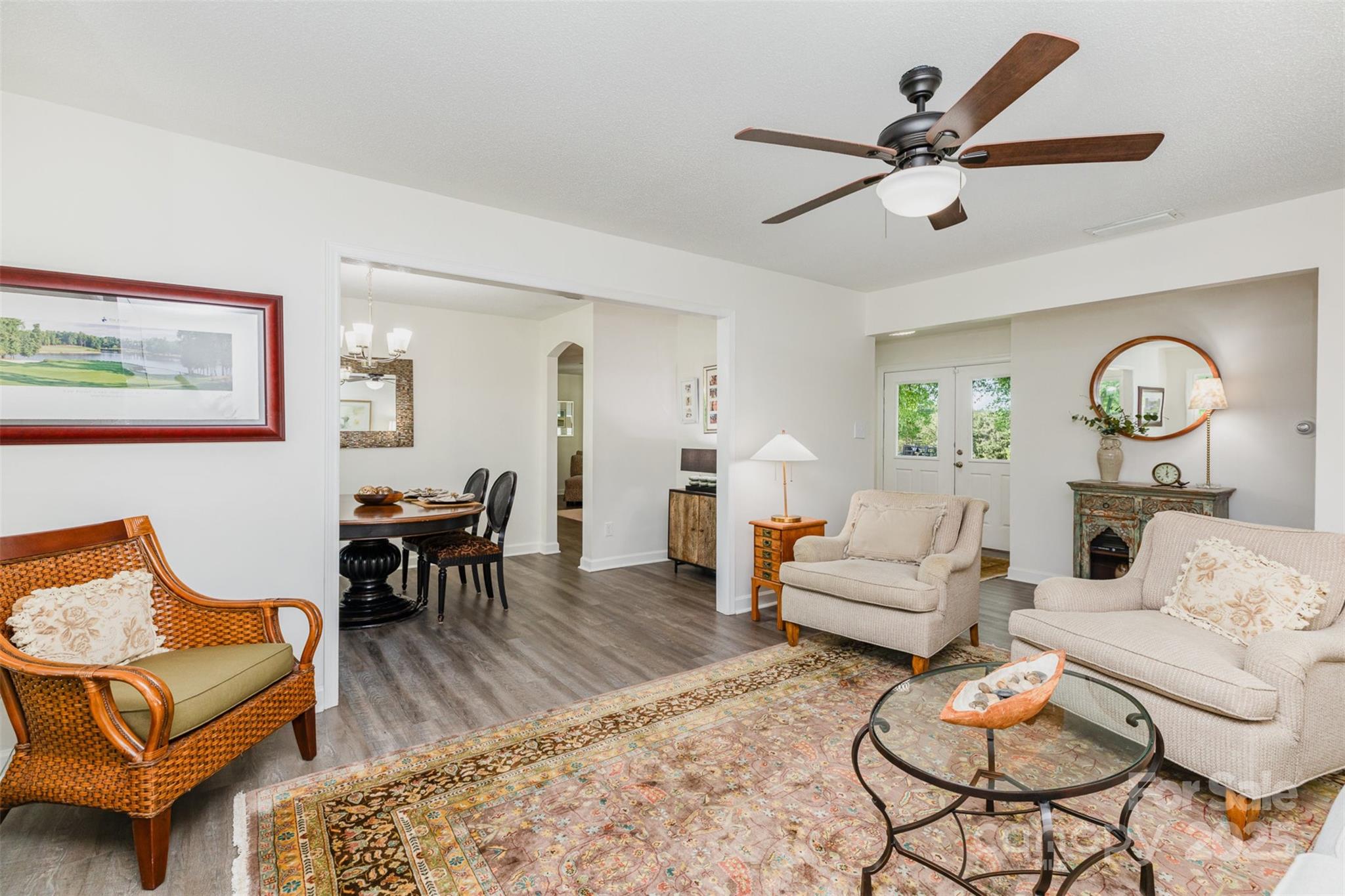 1041 Brawley School Road Mooresville, NC 28117 - Photo 5 of 19 a living room with furniture a clock on wall and a window