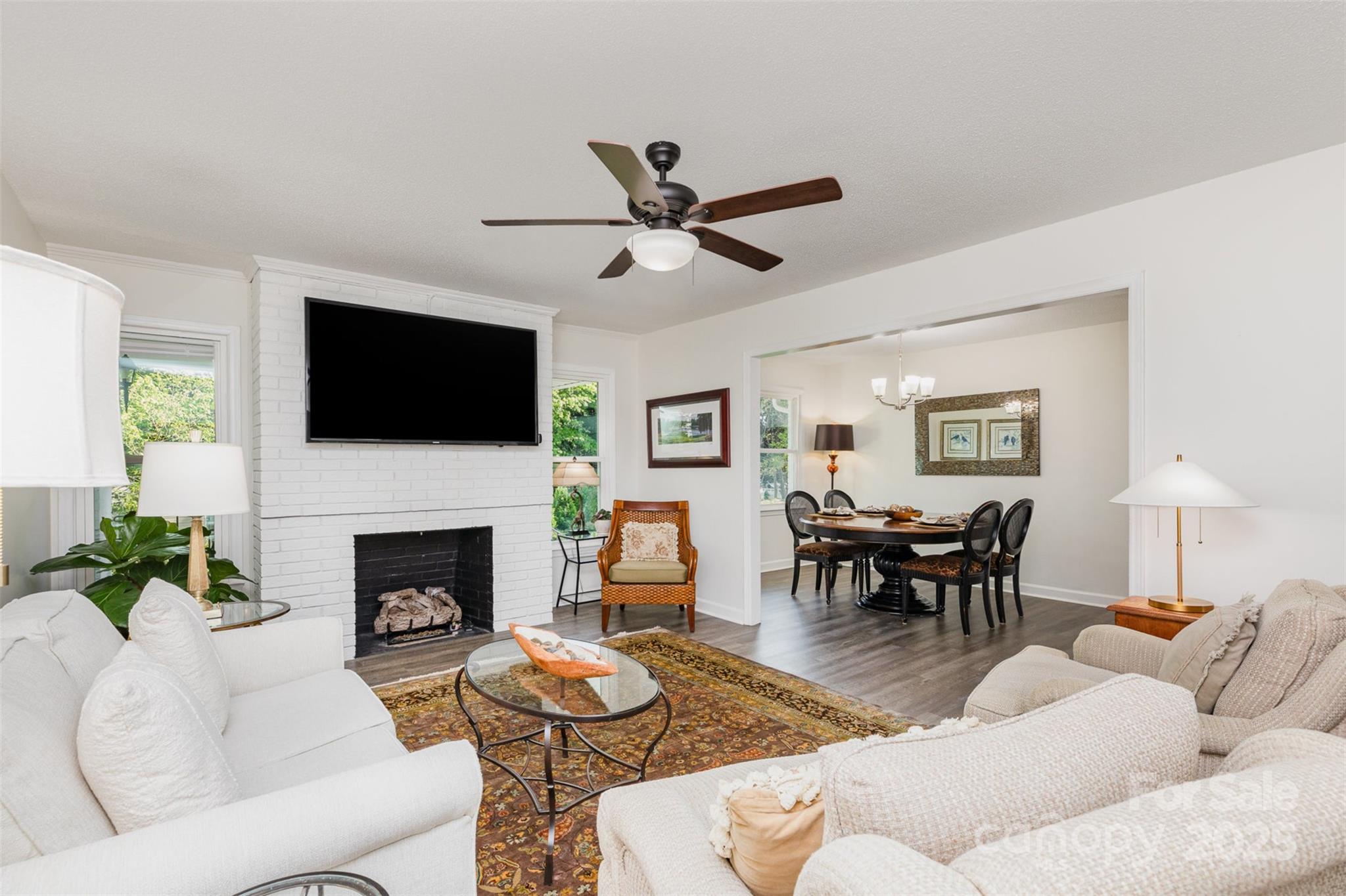 1041 Brawley School Road Mooresville, NC 28117 - Photo 6 of 19 a living room with furniture a fireplace and a flat screen tv