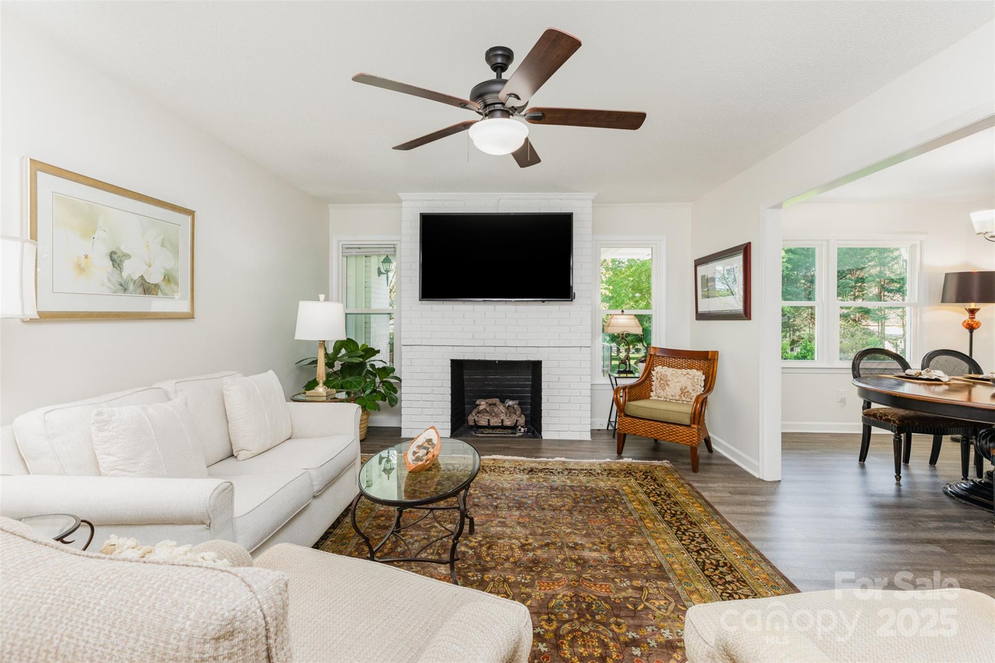1041 Brawley School Road Mooresville, NC 28117 - Photo 7 of 19 a living room with furniture a flat screen tv and a fireplace