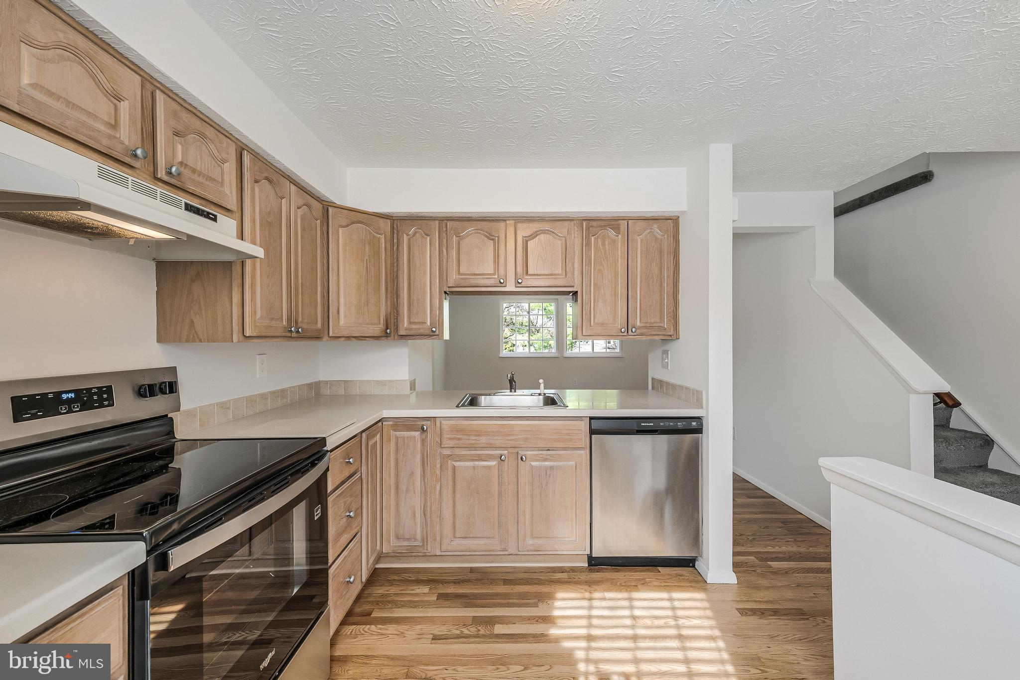1682 Harvest Green Court Reston, VA 20194 - Photo 11 of 39 a kitchen with stainless steel appliances granite countertop a stove and a sink