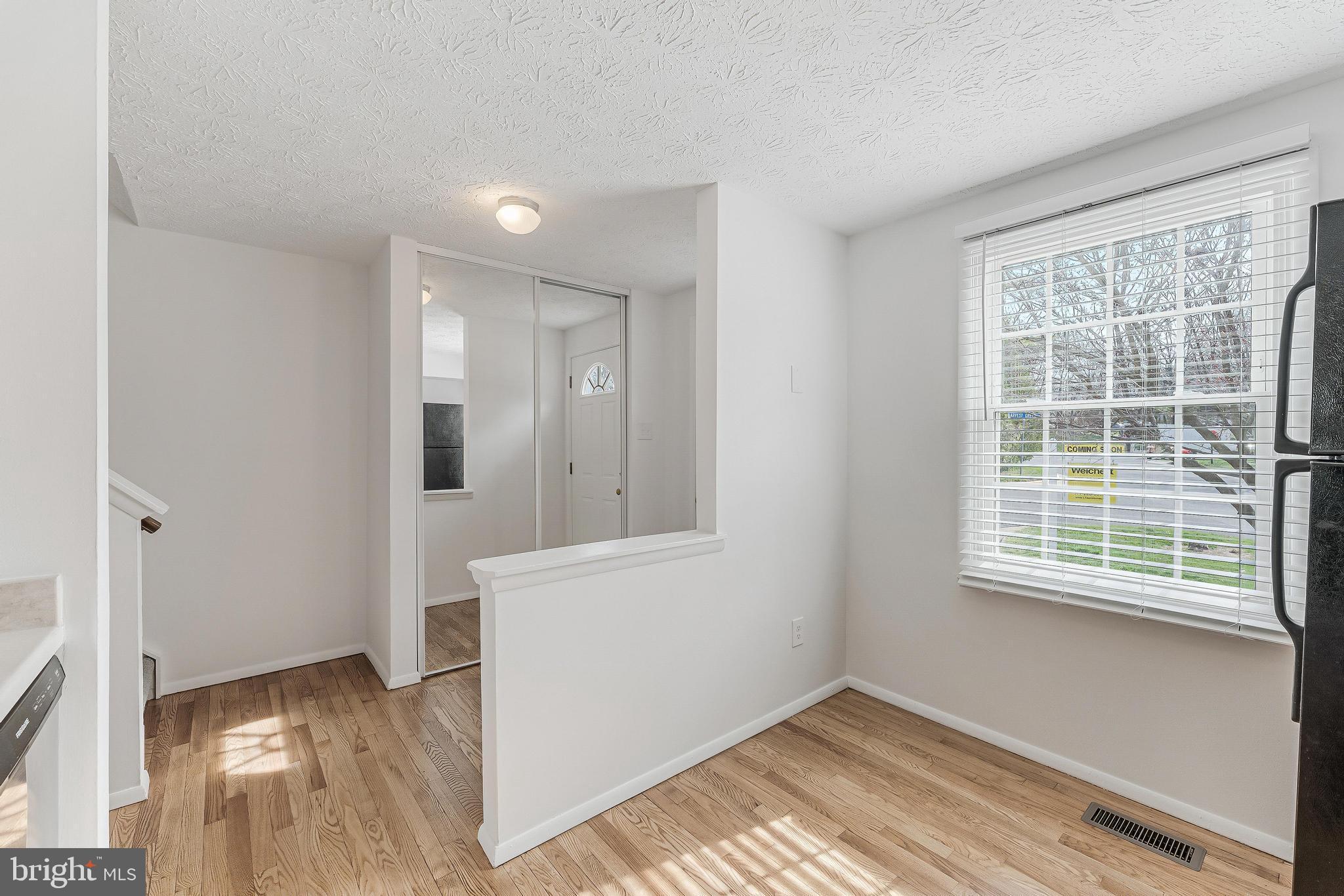 1682 Harvest Green Court Reston, VA 20194 - Photo 14 of 39 a view of an empty room with wooden floor and a window