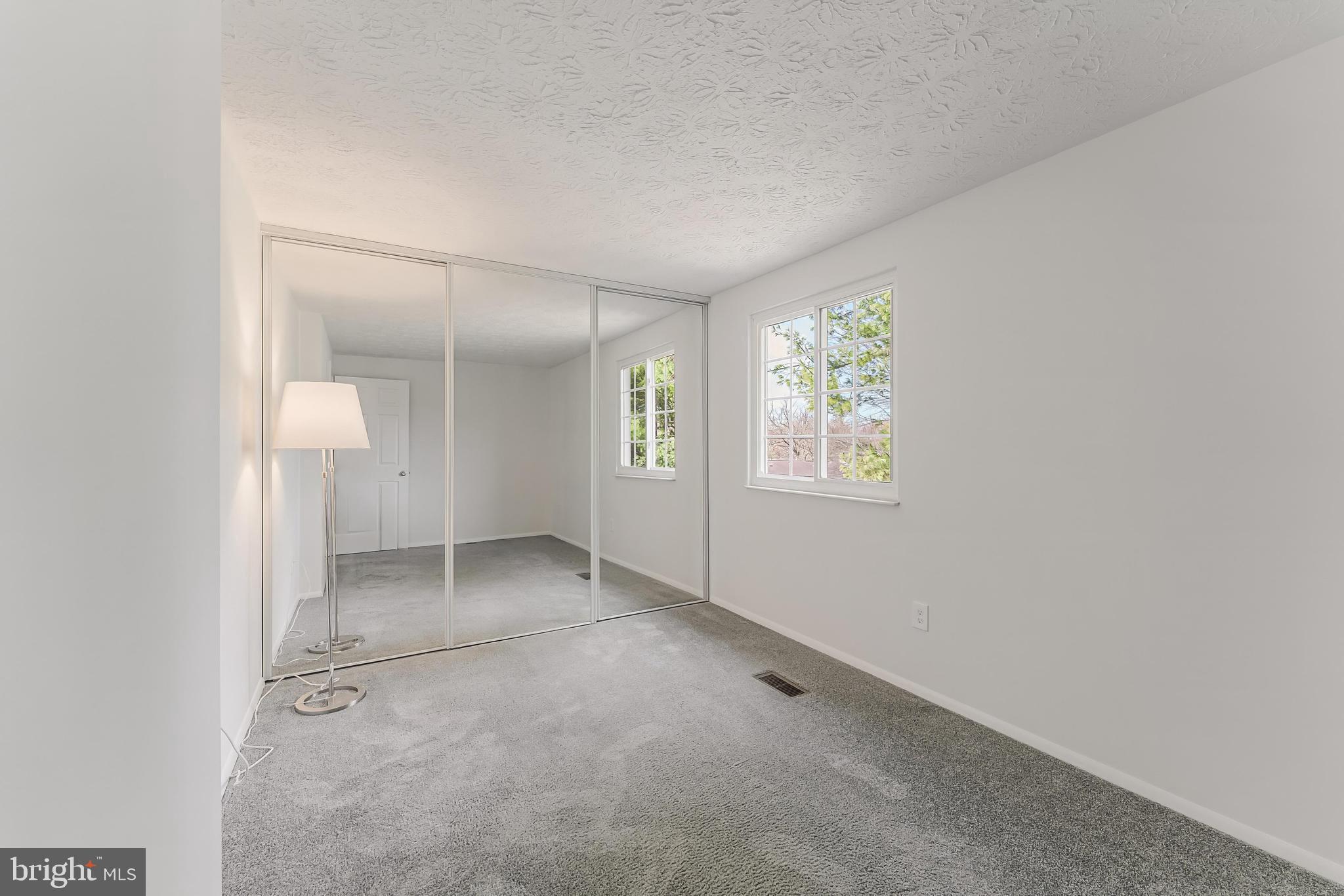 1682 Harvest Green Court Reston, VA 20194 - Photo 18 of 39 an empty room with windows and closet