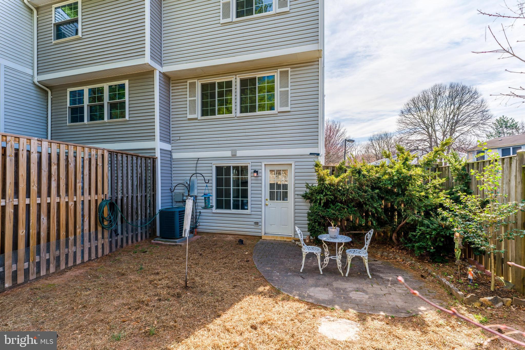 1682 Harvest Green Court Reston, VA 20194 - Photo 36 of 39 a view of a house with a patio and a yard