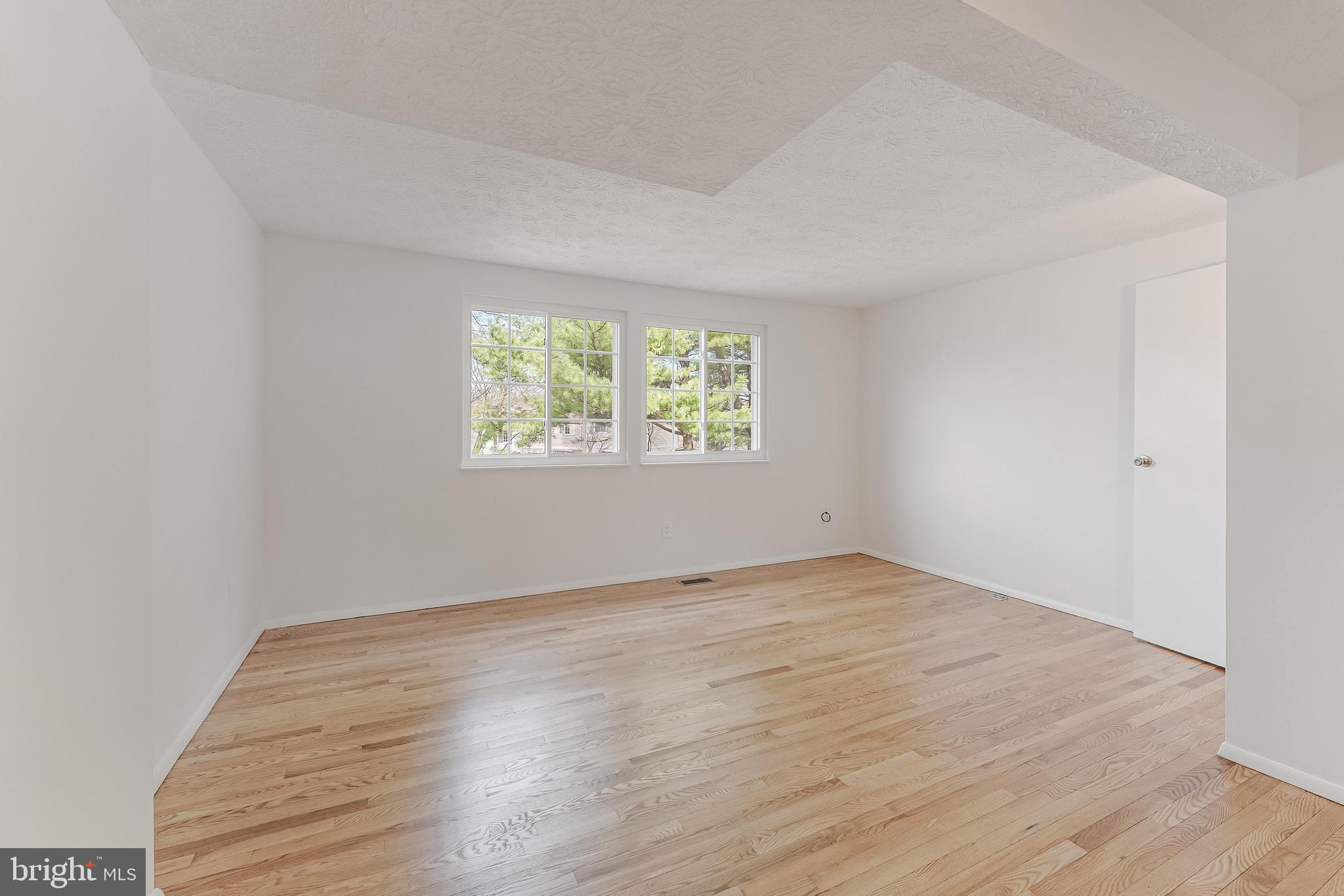 1682 Harvest Green Court Reston, VA 20194 - Photo 4 of 39 an empty room with wooden floor and windows