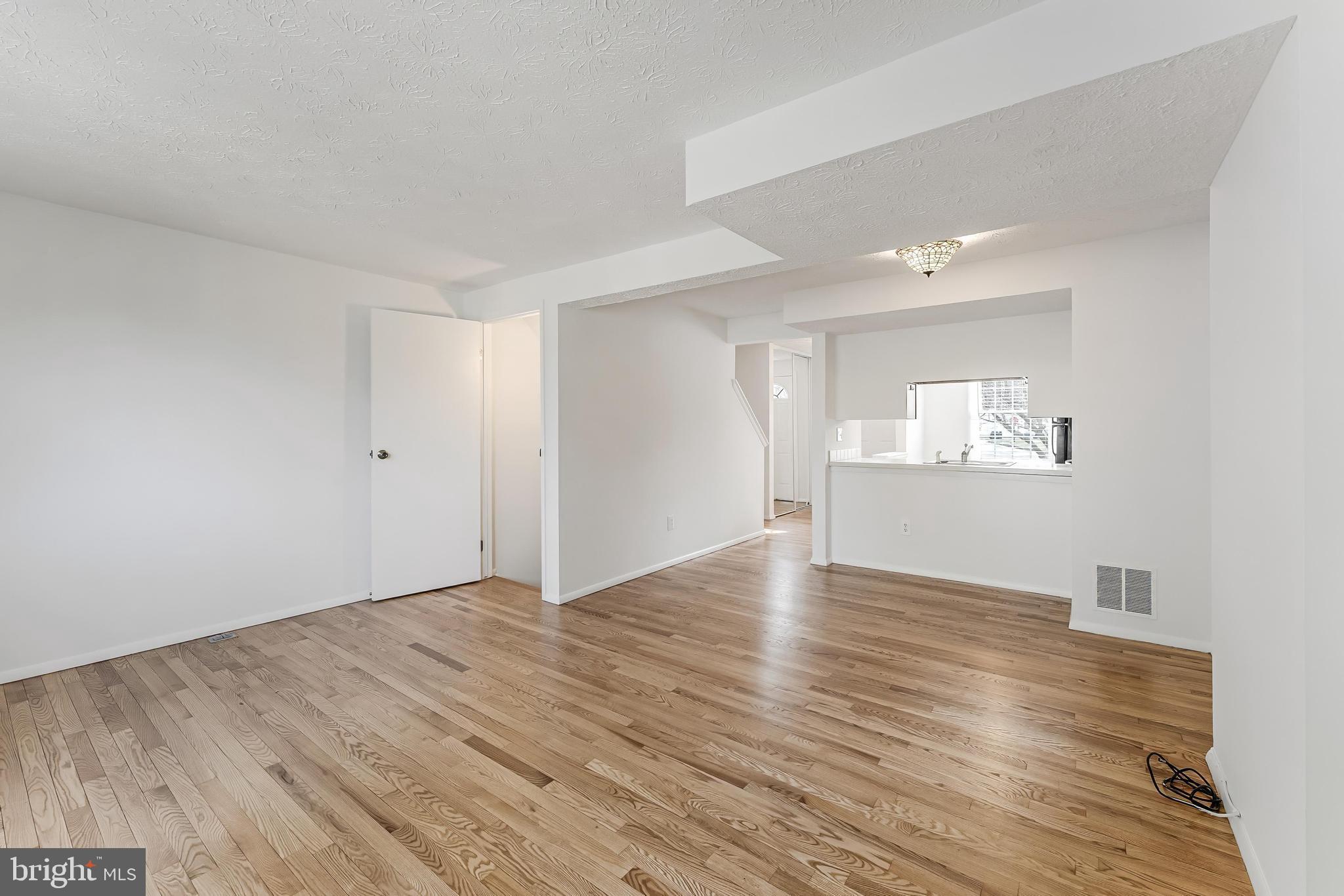 1682 Harvest Green Court Reston, VA 20194 - Photo 5 of 39 a view of an empty room with wooden floor and a window