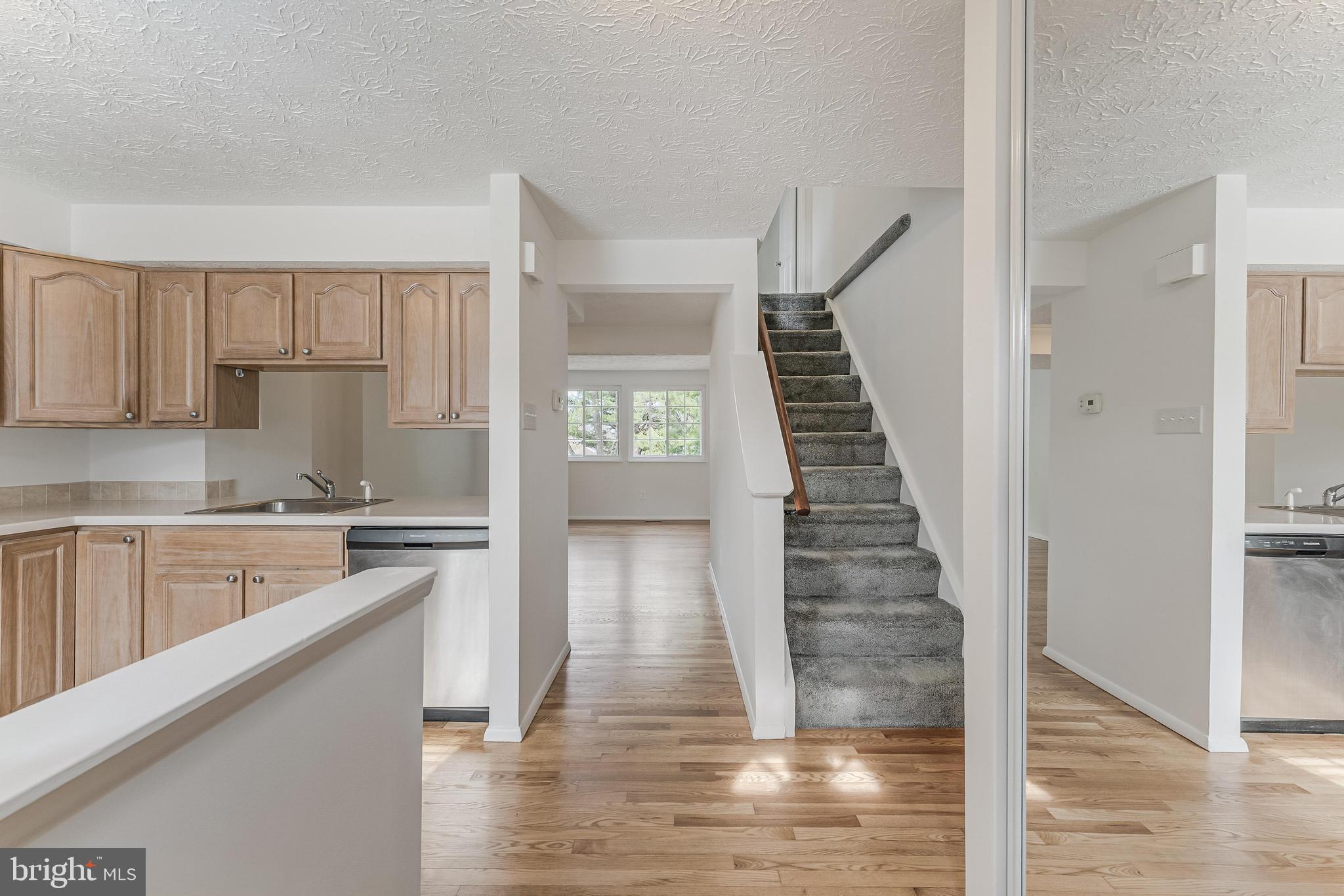1682 Harvest Green Court Reston, VA 20194 - Photo 8 of 39 a kitchen with wooden floors sink and cabinets