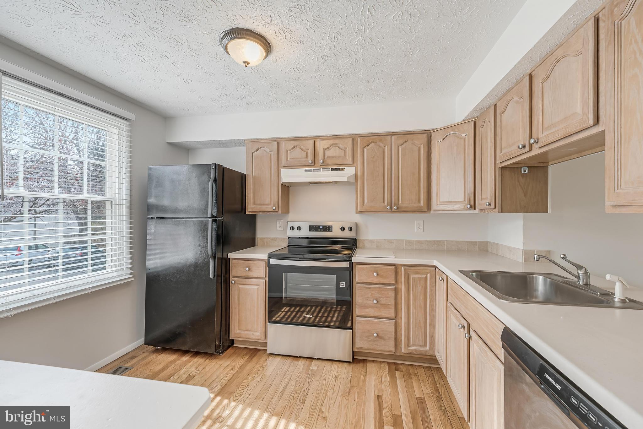 1682 Harvest Green Court Reston, VA 20194 - Photo 9 of 39 a kitchen with a sink cabinets stainless steel appliances and a window