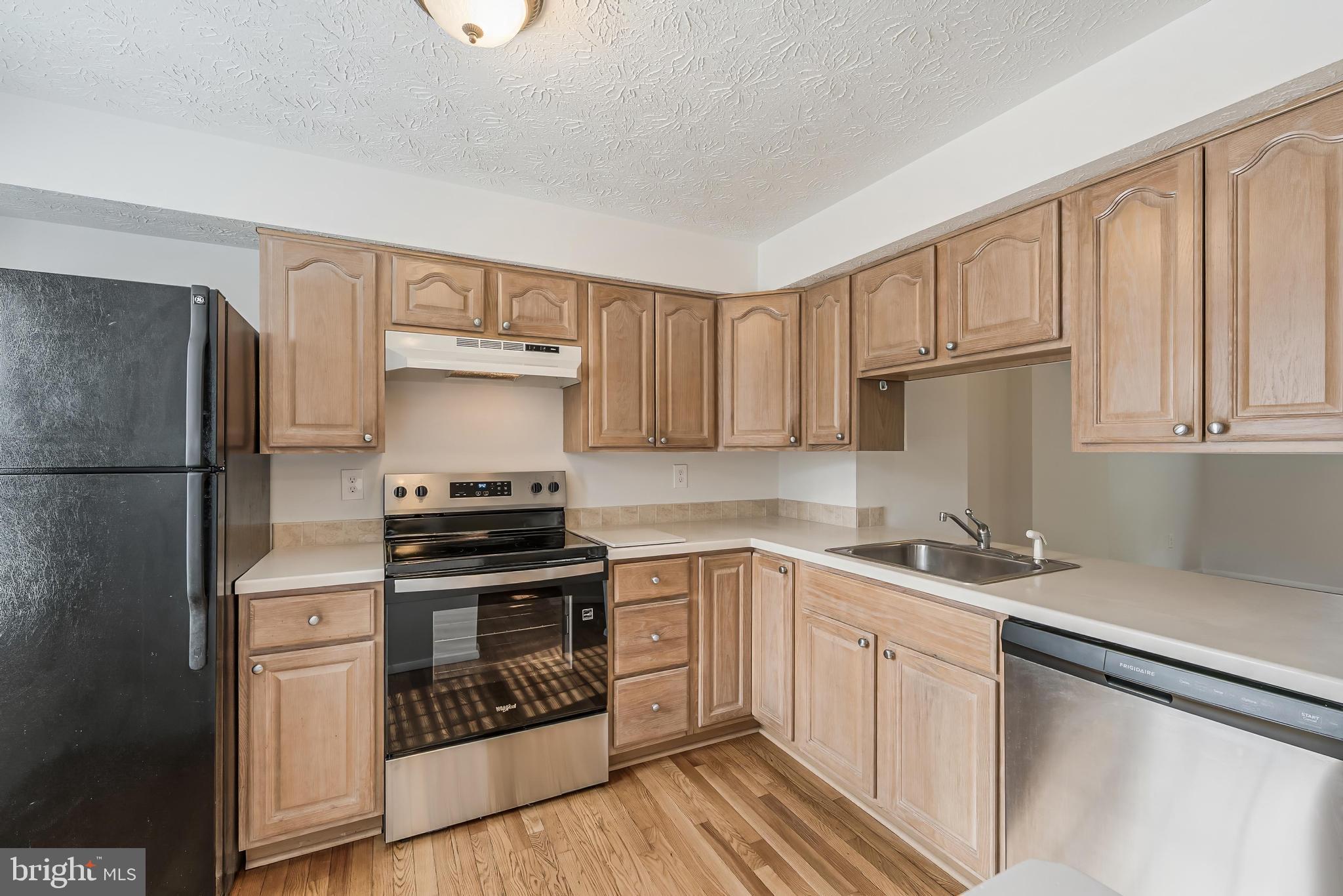 1682 Harvest Green Court Reston, VA 20194 - Photo 10 of 39 a kitchen with cabinets stainless steel appliances and a sink