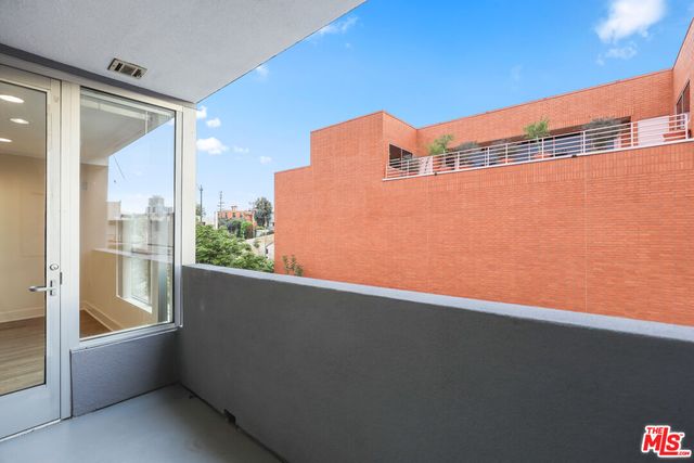a view of a balcony with a floor to ceiling window and stairs