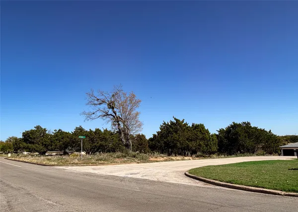 a view of a grassy area with an ocean