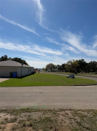 a view of a yard with a tree