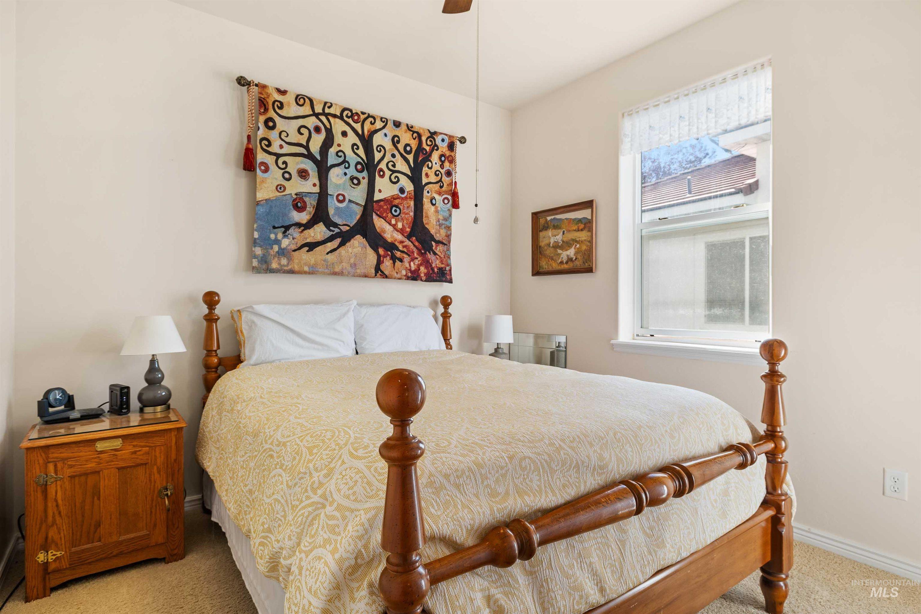 215 Los Lagos Twin Falls, ID 83301 - Photo 16 of 30 Bedroom with light colored carpet and ceiling fan