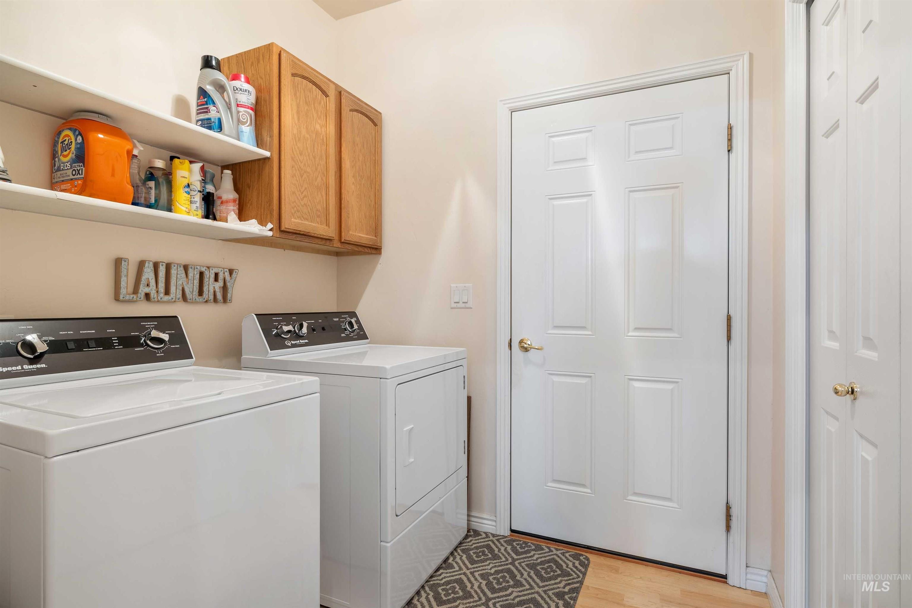 215 Los Lagos Twin Falls, ID 83301 - Photo 21 of 30 Laundry room with independent washer and dryer, cabinet space, and light wood-type flooring
