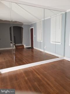 5358 Cuthbert Avenue Baltimore, MD 21215 - Photo 14 of 20 a view of an empty room with window and wooden floor