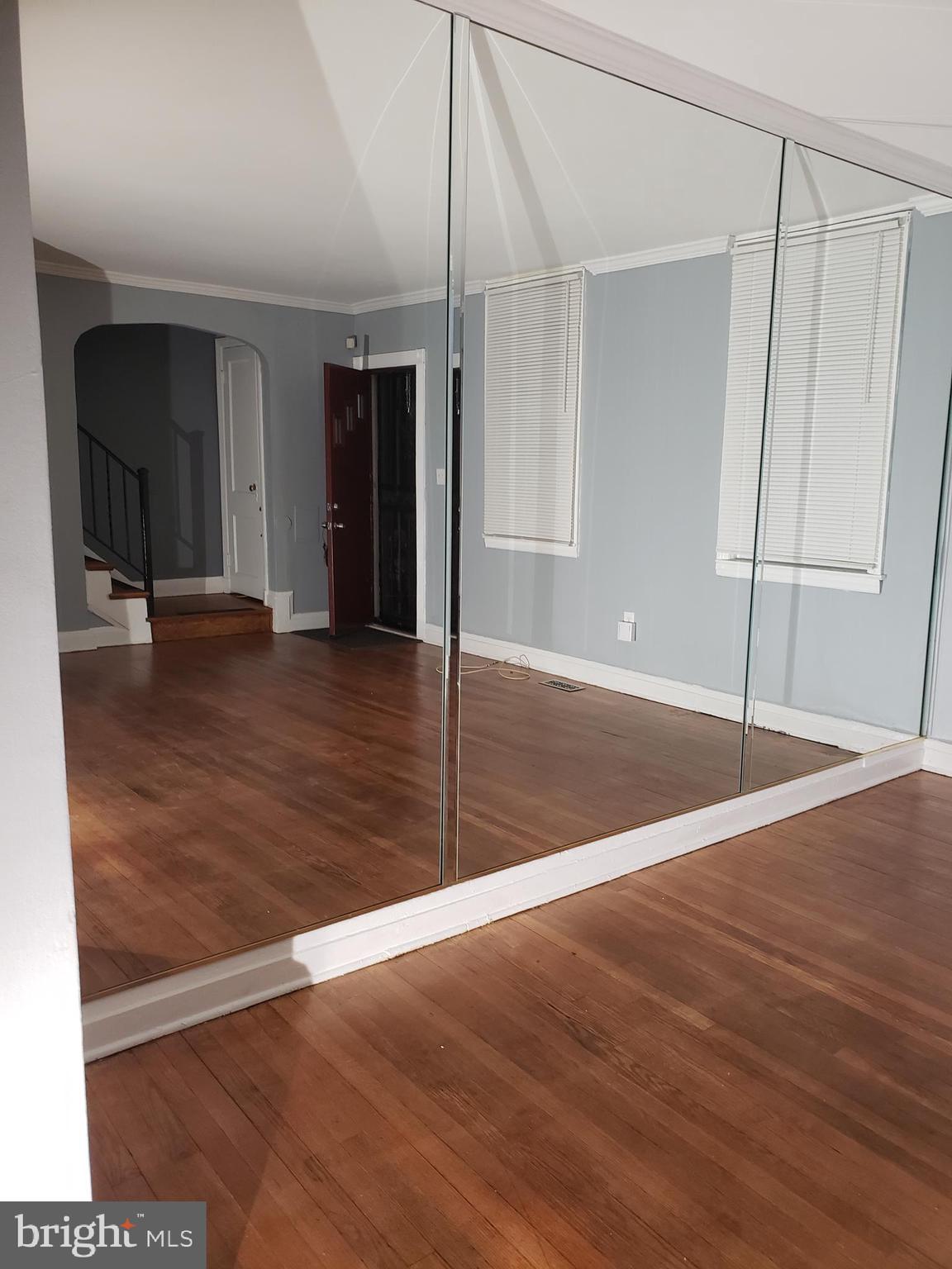5358 Cuthbert Avenue Baltimore, MD 21215 - Photo 4 of 7 a view of an empty room with wooden floor