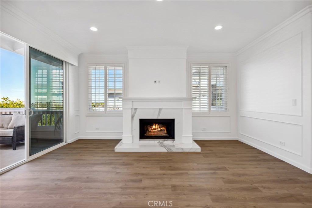 3521 Geranium Avenue, Unit 22 Corona del Mar, CA 92625 - Photo 12 of 37 an empty room with windows and fireplace
