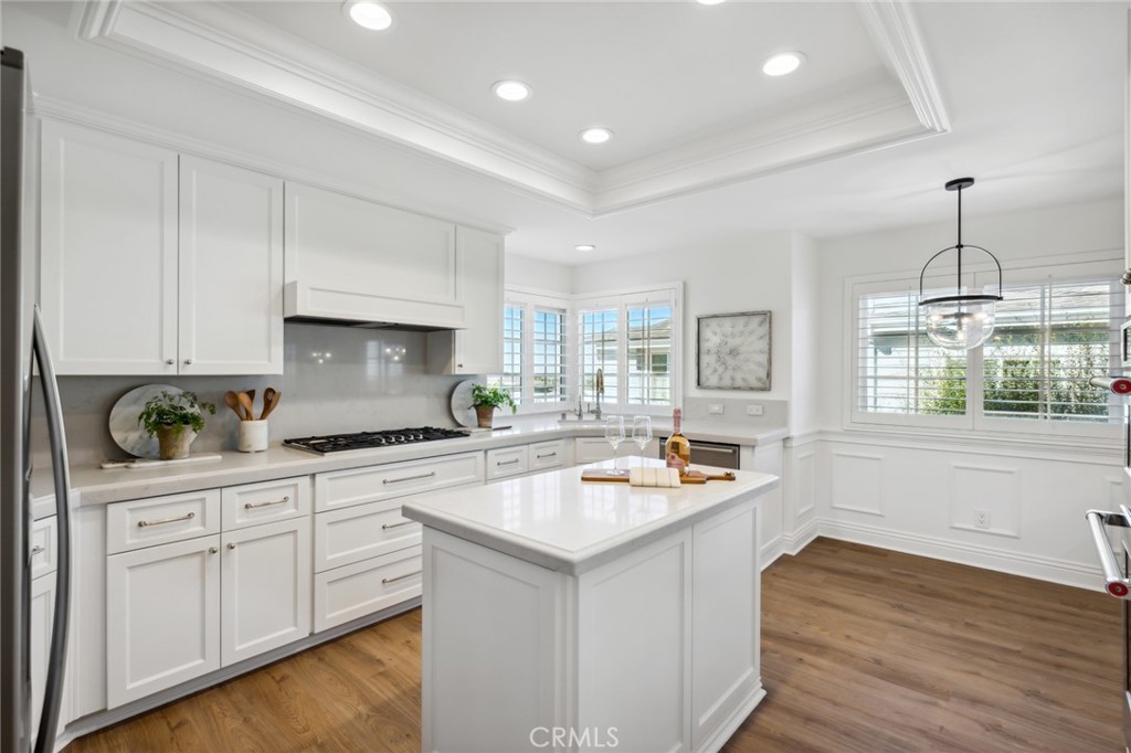 3521 Geranium Avenue, Unit 22 Corona del Mar, CA 92625 - Photo 13 of 37 a kitchen with white cabinets and window