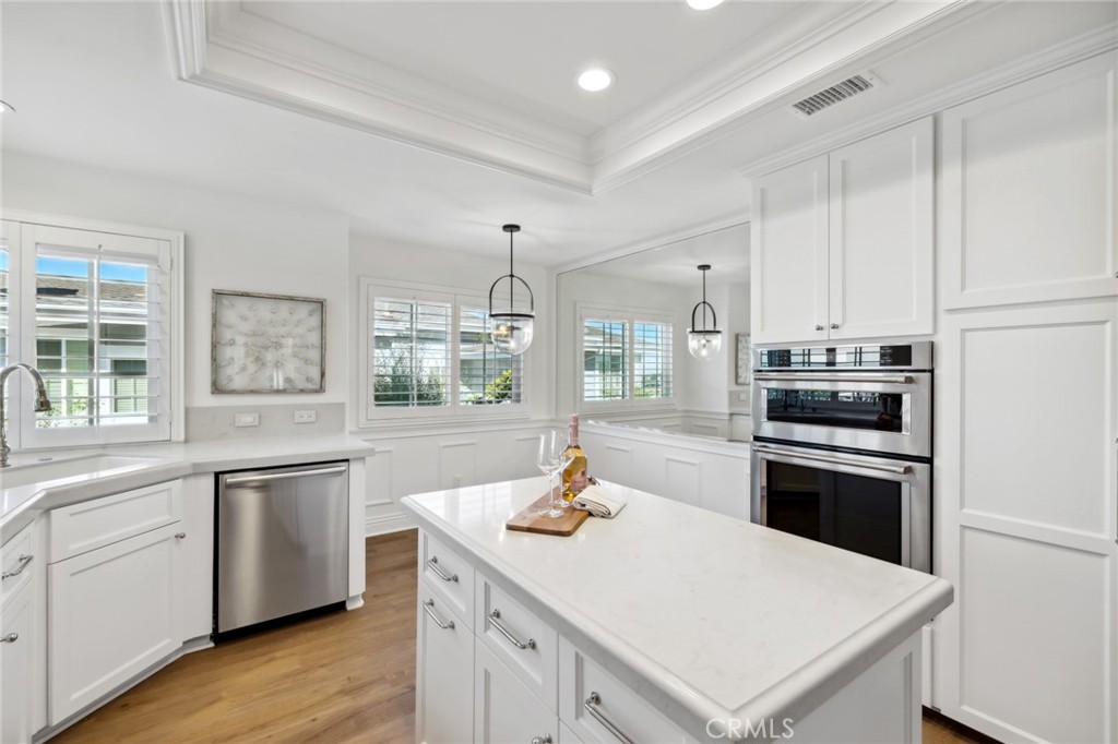 3521 Geranium Avenue, Unit 22 Corona del Mar, CA 92625 - Photo 16 of 37 a kitchen with a stove a sink and a refrigerator