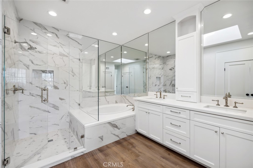 3521 Geranium Avenue, Unit 22 Corona del Mar, CA 92625 - Photo 26 of 37 a large bathroom with a double vanity sink toilet mirror and bathtub
