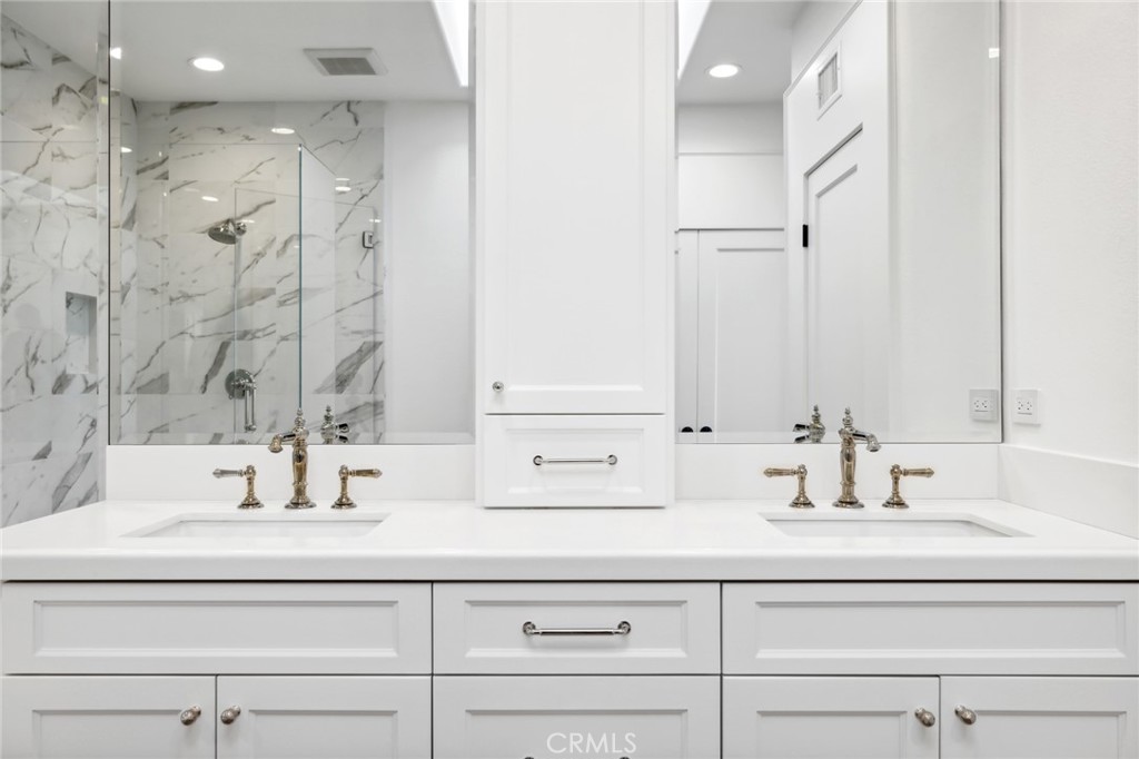3521 Geranium Avenue, Unit 22 Corona del Mar, CA 92625 - Photo 27 of 37 a bathroom with double vanity sink and a mirror