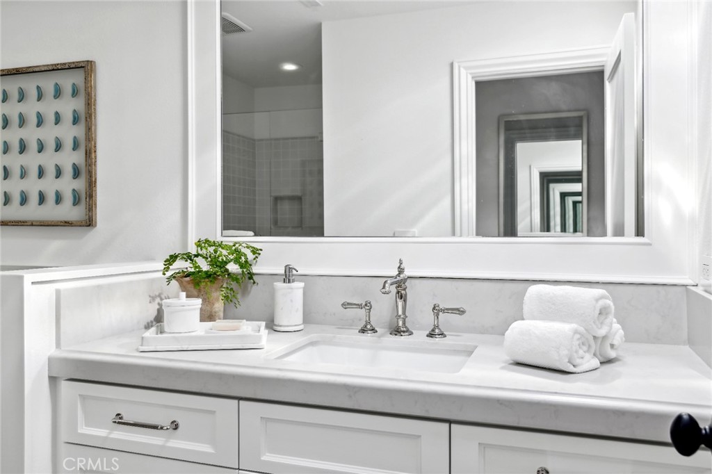 3521 Geranium Avenue, Unit 22 Corona del Mar, CA 92625 - Photo 30 of 37 a bathroom with a sink and a mirror