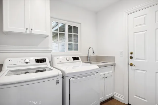 a view of washer and dryer with bathroom in it
