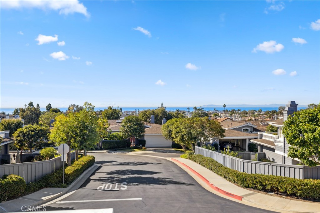 3521 Geranium Avenue, Unit 22 Corona del Mar, CA 92625 - Photo 32 of 37 a view of a house with a yard and potted plants